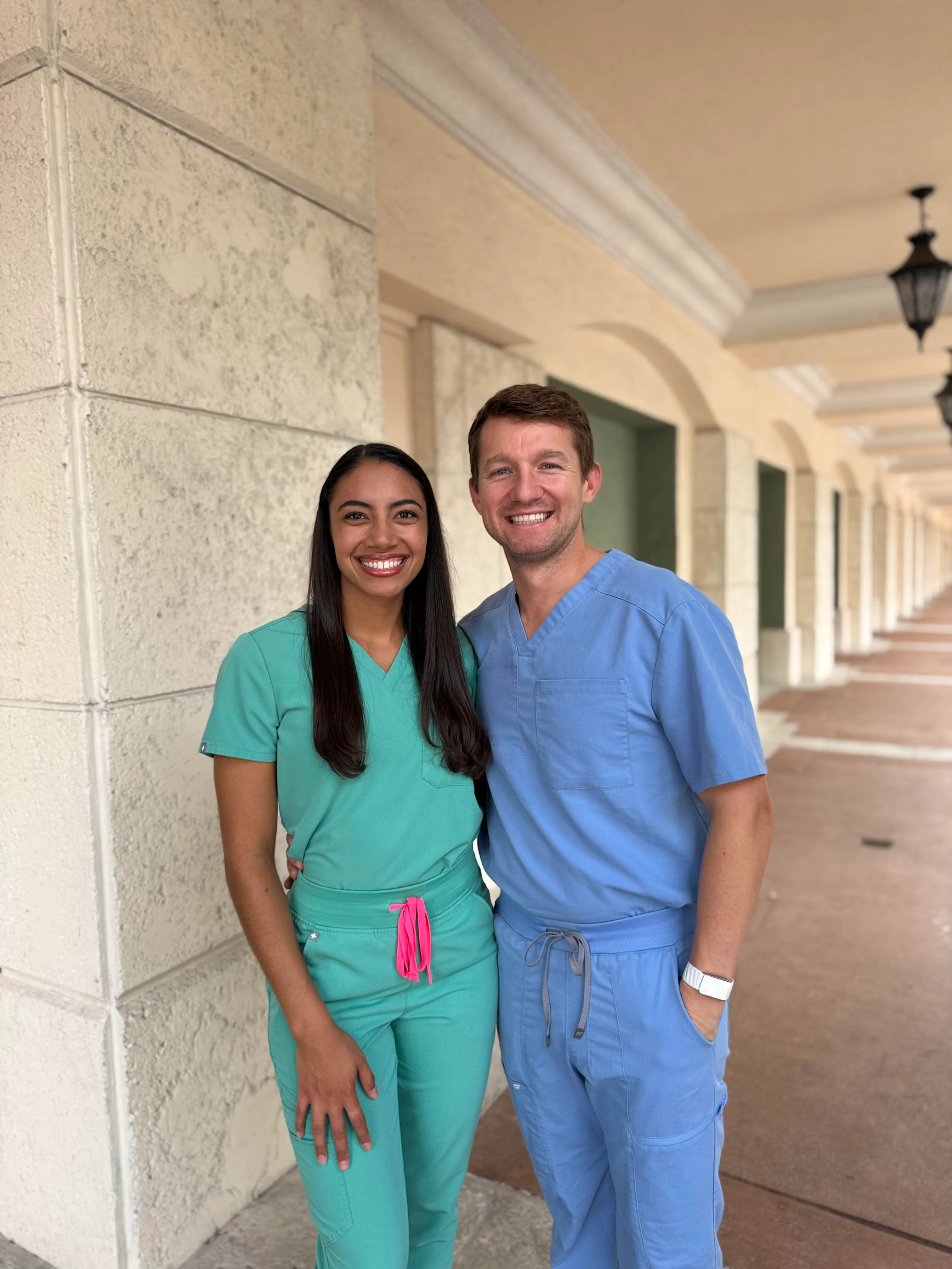 Angel and Nick, co-founders of Angel Dust, in scrubs outside the hospital
