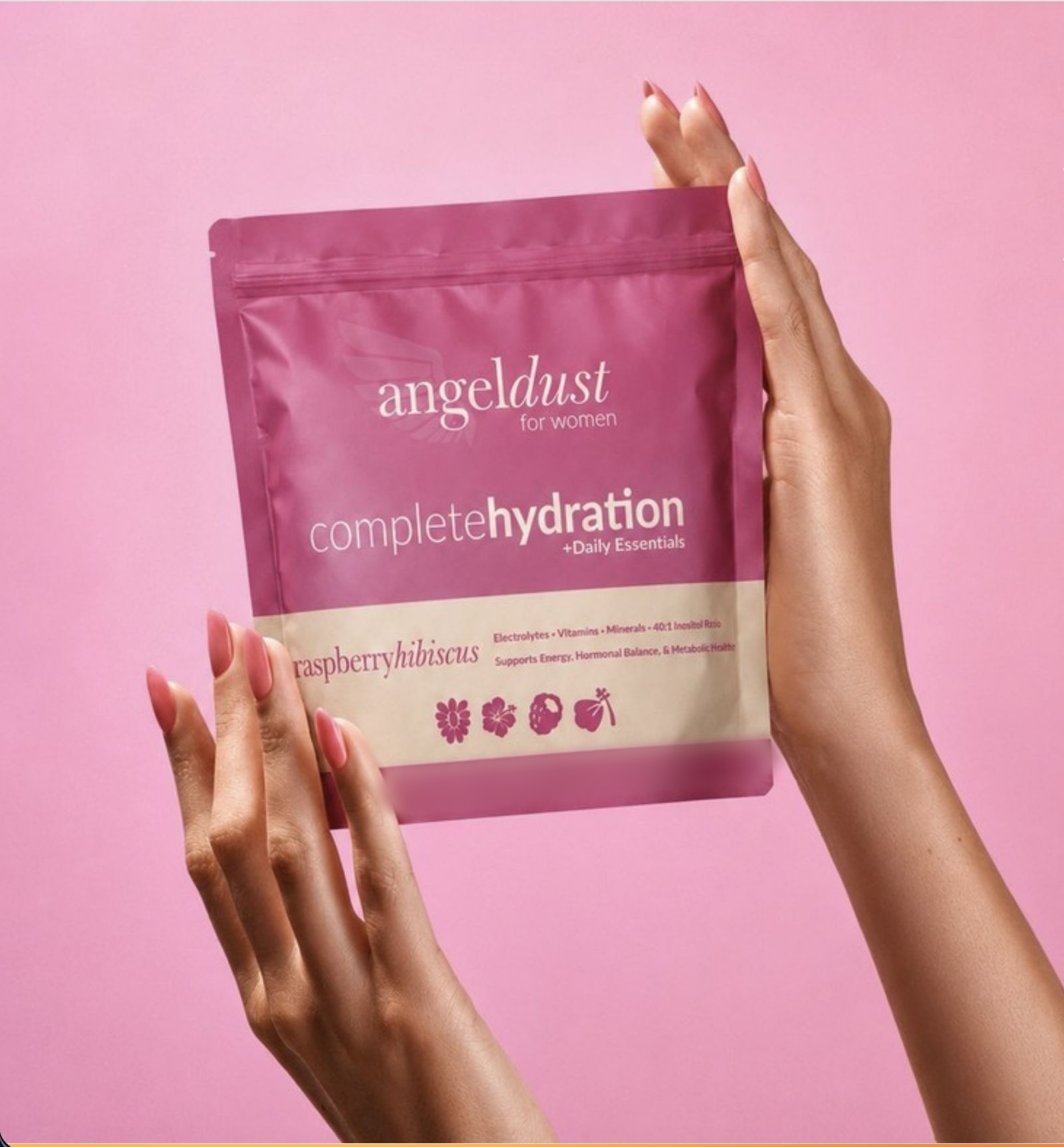 Hands holding up a pouch of Angel Dust raspberry hibiscus against a pink backdrop